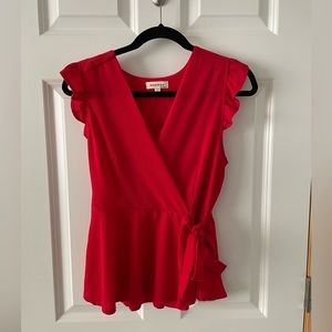 Size large red top with ruffle sleeves and front tie.
